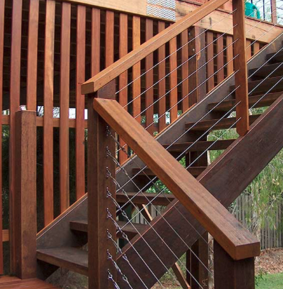 Stained hardwood stairs with cable railing
